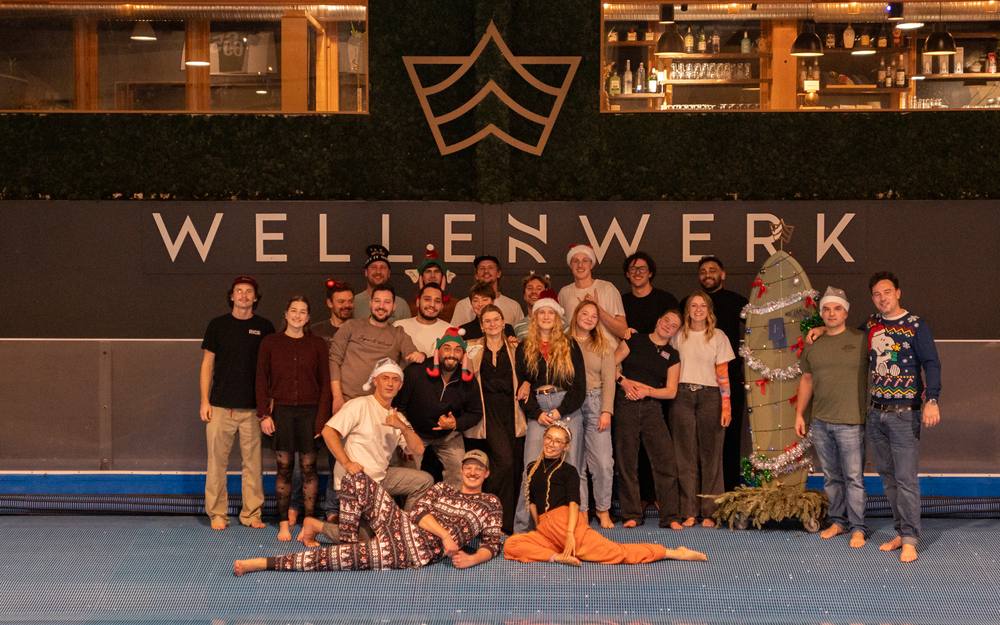 The Wellenwerk team in front of the wave (Christmas party 2025)